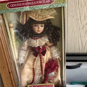 Classic Porcelain Doll with Brown Hair and Cream Dress